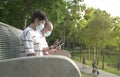 Senior Asian couple wearing face mask and reading their phones Royalty Free Stock Photo