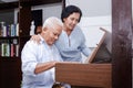 Senior Asian elderly couple Have fun playing the electric piano together. Royalty Free Stock Photo