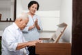 Senior Asian elderly couple Have fun playing the electric piano together. Royalty Free Stock Photo