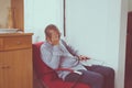 Senior asian elderly man having migraine and headache pain while sitting on sofa at home,Elderly healthy concept