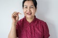 Senior Asian woman is holding dentures in hands,Dental prosthesis,False teeth,Close up