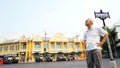 Senior Asian guy in front of Classic Thai architecture at na phra lan road