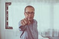 Senior asian man points his finger to you,Close up,Selective focus face Royalty Free Stock Photo