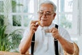 Elderly Asian man taking pill Royalty Free Stock Photo