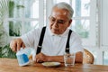 Elderly Asian man taking pill Royalty Free Stock Photo