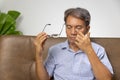 Senior asian man has eyestrain and fatigue Royalty Free Stock Photo