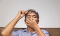 Senior asian man has eyestrain and fatigue Royalty Free Stock Photo