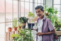 Senior man having morning coffee in his houseplant garden glasshouse home Royalty Free Stock Photo