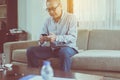 Senior asian man having rest and using smartphone connecting internet at home,Relaxing time,Happy and smiling