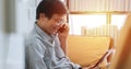 Senior Asian man playing tablet and video call on sofa in living room at home  Portrait of Asian elderly man is Relaxing and Royalty Free Stock Photo