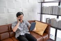 Senior Asian man playing tablet and video call on sofa in living room at home  Portrait of Asian elderly man is Relaxing and Royalty Free Stock Photo