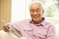 Senior Asian man reading newspaper Royalty Free Stock Photo