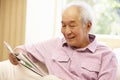 Senior Asian man reading newspaper Royalty Free Stock Photo