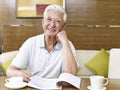 Senior asian man reading in study room Royalty Free Stock Photo