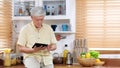 Senior asian man using digital tablet at home background, Elderly asia male and digital tablet standing in kitchen, Active old Royalty Free Stock Photo