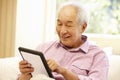 Senior Asian man using tablet Royalty Free Stock Photo