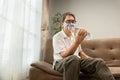 Senior asian man workout water bottle at home to preserve his muscle mass, prevent sarcopenia and bone resorption
