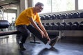 Senior asian sport man stretching his leg  in fitness gym . elder male exercising ,  working out , training , healthy ,Retirement Royalty Free Stock Photo