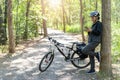 Senior asian woman bicycle in the park, With using smart phone