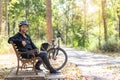 Senior asian woman bicycle with sitting in the park Royalty Free Stock Photo