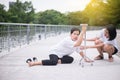 Senior asian woman with faint sitting on floor after falling down,female take care and support