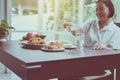 Senior Asian woman hands pouring water to glass,Elderly healthy concept Royalty Free Stock Photo