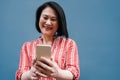 Senior asian woman having fun using mobile phone outdoor - Focus on face Royalty Free Stock Photo