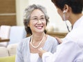 Senior asian woman having a physical check Royalty Free Stock Photo