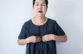 Senior asian woman having or symptomatic reflux acids,Gastroesophageal reflux disease,Copy space on white background Royalty Free Stock Photo