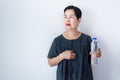 Senior asian woman having or symptomatic reflux acids,Gastroesophageal reflux disease,Drinking water Royalty Free Stock Photo