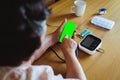 Senior asian woman is measuring blood pressure and heart rate with digital pressure gauge electric tonometer by herself at home