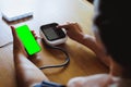 Senior asian woman is measuring blood pressure and heart rate with digital pressure gauge electric tonometer by herself at home