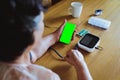 Senior asian woman is measuring blood pressure and heart rate with digital pressure gauge electric tonometer by herself at home