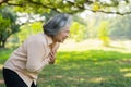 Senior Asian woman problem chest pains or heart attack outdoor in park, heart problems, a senior woman with chest ache suffering Royalty Free Stock Photo