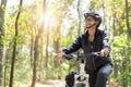 Senior asian woman riding bikes in park with hold and look map