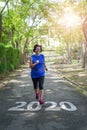 Senior asian woman start to new year 2020 plans goals happy jogging running in the park Royalty Free Stock Photo