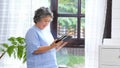 Senior asian woman using digital tablet computer at home background, Retirement asian woman and digital tablet standing by home Royalty Free Stock Photo