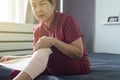 Senior Asian woman using elastic bandage with leg,Female putting bandage on her injured knee Royalty Free Stock Photo