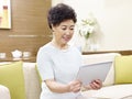 Senior asian woman using tablet computer Royalty Free Stock Photo