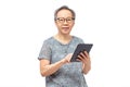 Senior asian woman wearing eyeglasses and using digital tablet, looking at camera with smile Royalty Free Stock Photo