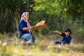 Senior Asian woman work with winnow rice using basketry and little girl stay beside and also work with rice