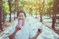 Senior asian woman drinking water after break workout at public park in the morning,Healthy elderly woman concept Royalty Free Stock Photo