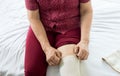 Senior asian woman using elastic bandage with leg,Female putting bandage on her injured knee Royalty Free Stock Photo