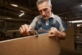 Close up of professional carpenter using tool for work