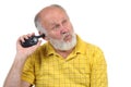 Senior bald man's picking his ear