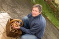 Senior with a basket walnuts