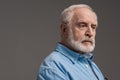 Senior bearded man isolated on grey in studio