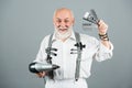 Senior bearded man, bearded old male. Portrait of vintage barber. Barber scissors and straight razor, hair dryer in Royalty Free Stock Photo