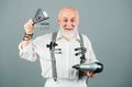 Senior bearded man, bearded old male. Portrait of vintage barber. Barber scissors and straight razor, hair dryer in Royalty Free Stock Photo