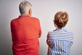 Senior beautiful couple standing together over isolated white background standing backwards looking away with crossed arms Royalty Free Stock Photo